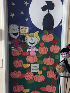 a door decorated for halloween with pumpkins and characters