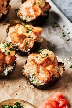 an assortment of stuffed mushrooms with cheese and herbs on the top, next to tomatoes