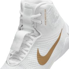 the nike zoom flyknit basketball shoe is white and gold