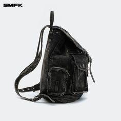 SMFK Compass Tarpan Denim Backpack Black (Large) - Design: A fresh design for 2024 by SMFK, this denim backpack is a new addition to their collection. The design takes inspiration from common detailing found in denim jackets and shorts, allowing for adjustable capacity. Features a three-dimensional external pocket, echoing the workwear pocket style from SMFK's workwear collection. Size F - Length: 35cm, Width: 17.5cm, Height: 41cm Composition: 72.8% Cotton, 23.6% Polyester, 3.6% Viscose Denim Bags With Pockets For Streetwear, Denim Streetwear Bags With Pockets, Streetwear Denim Bags With Pockets, Streetwear Backpack With Multiple Pockets, Streetwear Backpack With Pockets, Denim Backpack, Shop Bags, Suit Pant, Bags Shop