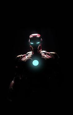 iron man in the dark with his hands on his chest and glowing green light behind him