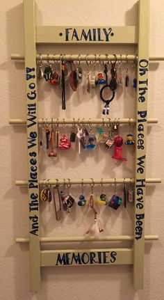 a wall mounted shelf with key hooks and magnets on it's sides that says, family