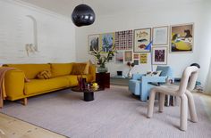 a living room filled with furniture and pictures on the wall