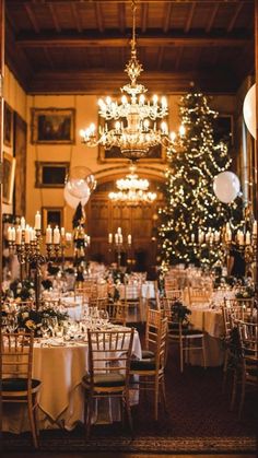 a dining room filled with lots of tables covered in white tablecloths and centerpieces