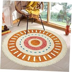 an orange and white rug with circles on the floor in front of a chair next to a window