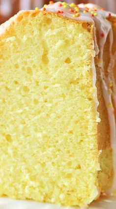 a close up of a slice of cake with icing and sprinkles