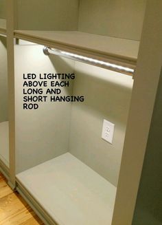 an empty walk in closet with white walls and black writing on the glass door that says led lighting above each long and short hanging rod