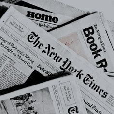 newspapers are piled on top of each other in this black and white photo, with the word'new york times'above them