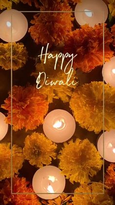 flowers and candles with the words happy diwali written in white on it's side