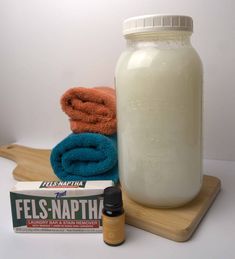 a bottle of fels - n - napht next to some towels and a tube of toothpaste