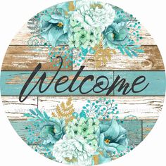 a sign that says welcome with flowers and leaves on the bottom of it, in front of a wooden background