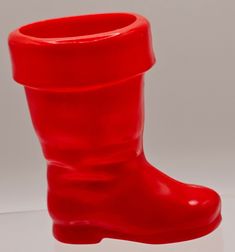 a red rubber boot sitting on top of a white table