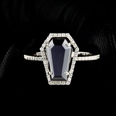 a black and white diamond ring on a black background