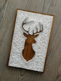 an embroidered deer head on a piece of wood