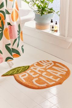 an orange door mat with the words papa peach on it in front of a bathroom window