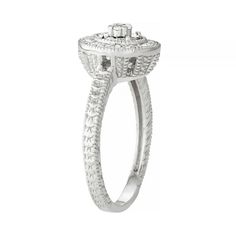 Adorned with round-cut diamonds, this sterling silver halo ring is simply stunning. Click on this JEWELRY & WATCHES GUIDE to learn about fit, styles, materials and more!RING DETAILS Width: 0.3 in. Metal: sterling silver Plating: rhodium Finish: polished Additional details: milgrain accents Packaging: boxed DIAMOND DETAILS Total weight: 1/10 ct. Shape: round Color grade: I-J Clarity: I2-I3 Setting: miracle, prong Gemstones may have been treated to enhance their appearance. Special care may be req Diamond White Halo Ring With Center Stone For Anniversary, Anniversary Halo Ring In Diamond White With Halo Setting, Silver Halo Ring With Pave Setting And Round Cut, Diamond White Round Halo Ring, Silver Halo Ring With Pave Setting, Diamond White Halo Round Ring, White Gold Halo Promise Ring, Diamond White Halo Jewelry For Anniversary, Round Halo Ring For Anniversary