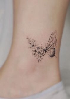 a small ankle tattoo with a butterfly and flowers on the back of the foot,