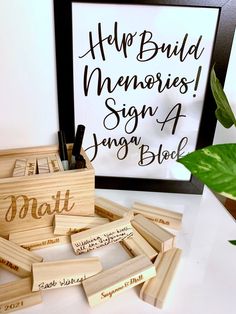 some wooden blocks with writing on them and a plant in the corner next to it