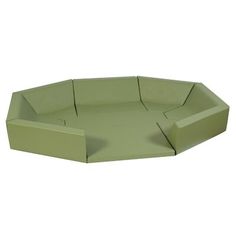 the corner sofa is green and has no cushions on it's back end,