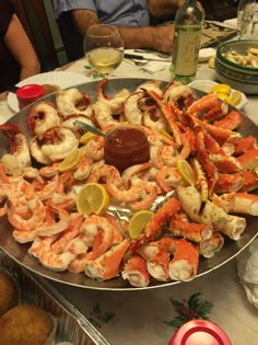 a platter full of shrimp and other seafood on a table