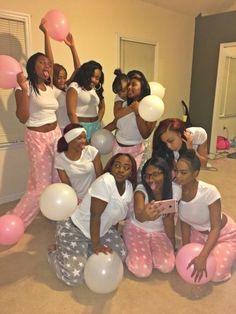 a group of young women posing for a photo with balloons