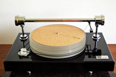 an old record player sitting on top of a table