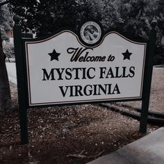 a welcome sign to mystic falls, virginia in black and white with stars on it