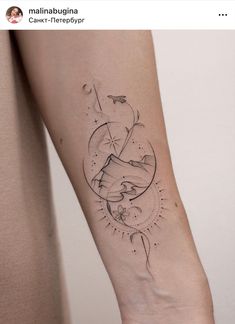 a woman's arm with a tattoo on it that has an image of the moon and stars