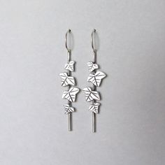 These beautiful dangle earrings are inspired by ivy leaves on a stem. They are impressive and are great to wear as wedding jewelry or for other special occasions. You can order them made of sterling silver or gold-plated silver with a nice matte finish. Each earring is 1.95 inches ( 5 cm ) long including the ear hoops, and the widest leaf is 0.39 inches ( 1 cm ). These earrings are "made to order" and take 2 - 4 weeks to make. Leaf Earrings Silver, Woodland Earrings, Leaves Earrings, Ivy Leaves, Gold Dangle Earrings, Ivy Leaf, Silver Dangle Earrings, Woodland Wedding, Etsy Earrings Dangle