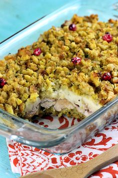 a casserole dish with meat and cranberries in it on a table