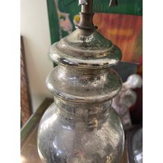 an old fashioned metal oil lamp on a table