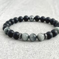 Features ~ 6mm or 8mm Matte Onyx beads ~ 6mm or 8mm Chrysoberyl beads ~ Hematite beads ~ Stretchy cord; simply slide bracelet on and off wrist ~ Comes packaged in a re-usable microfiber pouch To ensure the perfect fit, please use the bracelet sizing instructions found in the photo gallery. Onyx - A powerful protection stone, Black Onyx absorbs and transforms negative energy, and helps to prevent the drain of personal energy. Black Onyx aids the development of emotional and physical strength and Black Holistic Beaded Bracelets, Handmade Black Holistic Bracelets, Black Holistic Bracelets, Black Obsidian Beaded Bracelets, Men’s Freshwater Black Pearl Bracelet, Hematite Crystal, Physical Strength, Slide Bracelet, Personal Energy