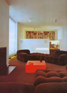 a living room filled with lots of brown furniture