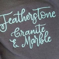 the back of a sweater that says, featherstone and marble on it's chest