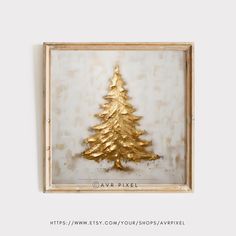 a gold christmas tree is hanging on the wall in front of a white and wood frame