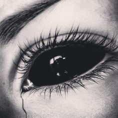 a woman's eye is shown with long lashes