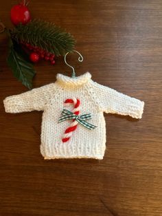 a knitted christmas sweater with candy cane on it