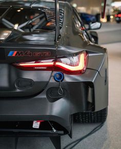 the back end of a bmw car parked in a garage