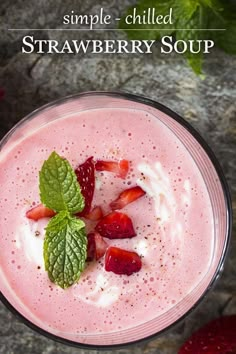 a smoothie with strawberries and whipped cream in a glass next to sliced strawberries