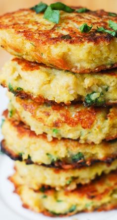 three crab cakes stacked on top of each other with green garnish and parsley