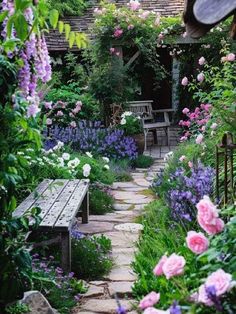 a garden with lots of flowers and benches