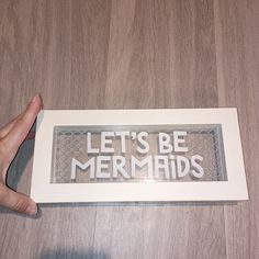 someone holding up a sign that says let's be mermaids