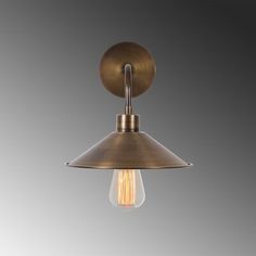 an old fashioned light fixture on a gray background