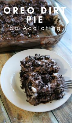 a piece of oreo dirt pie sitting on top of a white plate with a fork