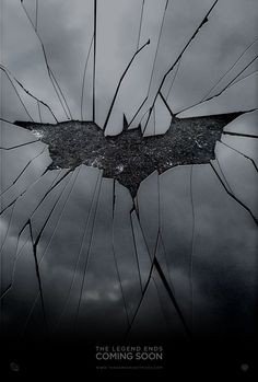 the dark knight rises logo is seen through broken glass in this scene from the batman movie