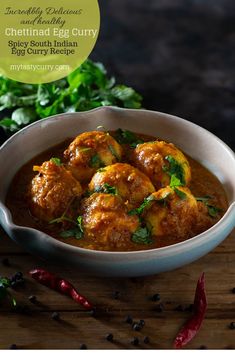 a white bowl filled with meatballs covered in sauce and garnished with parsley