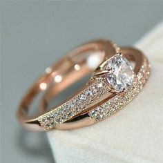 two wedding rings with diamonds on top of each other