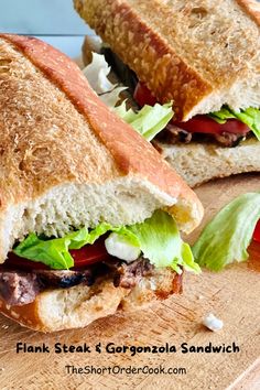 two sandwiches cut in half sitting on top of a cutting board