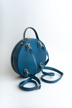 From handbag to crossbody or even a backpack, our Nyomi bag moves with you. Smooth vegan leather. Circle crossbody design. Soft detachable adjustable shoulder straps. Three interior pockets with additional zipper closure. Care instructions: To clean, wipe dry with a damp cloth. Do not use soap. Dimensions: 11" H X 11.5" W X 3" D Modern Travel Saddle Bag With Adjustable Handle, Modern Saddle Bag With Adjustable Handle For Travel, On-the-go Crossbody Satchel With Detachable Strap, Travel Crossbody Satchel With Adjustable Strap, Everyday Satchel Backpack With Detachable Strap, Daily Satchel Backpack With Detachable Strap, Daily Use Saddle Bag Backpack With Adjustable Strap, Detachable Handle Crossbody Shoulder Bag, Travel Saddle Shoulder Bag With Adjustable Handle