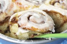 cinnamon rolls with icing in a metal pan